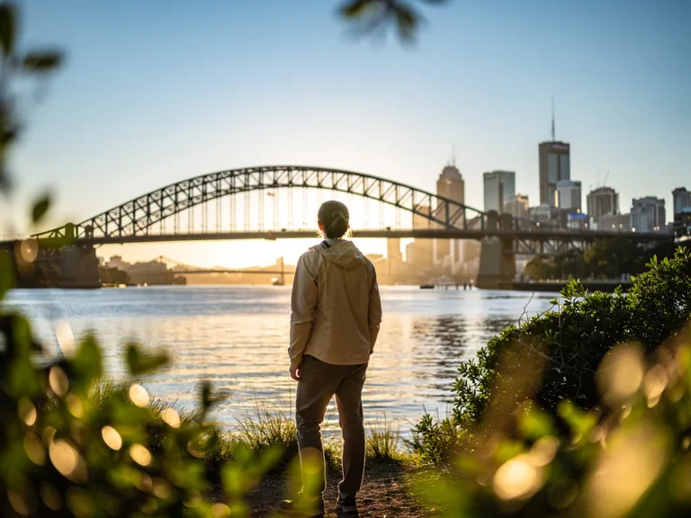 A lone adventurer enjoying Brisbane's mild winter weather with the Story Bridge and city skyline visible under clear blue skies
